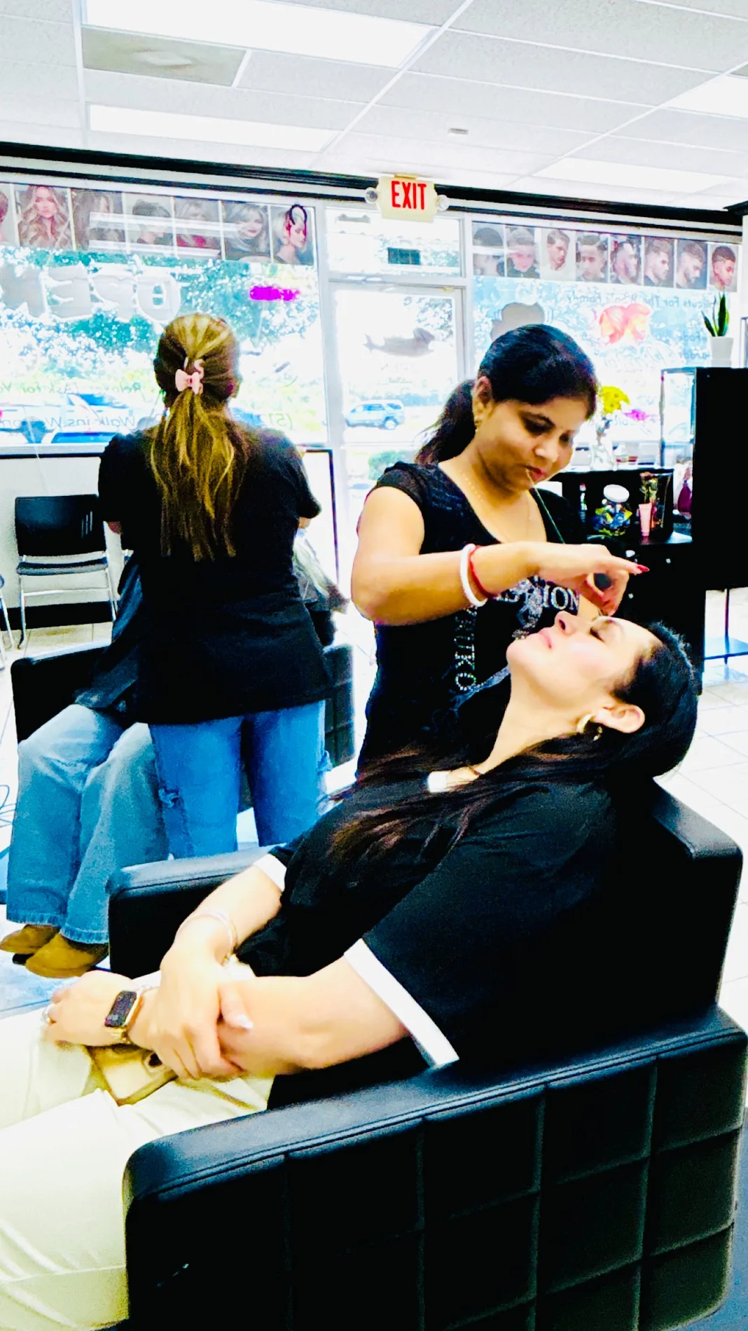 Shivani threading a customer's eyebrows